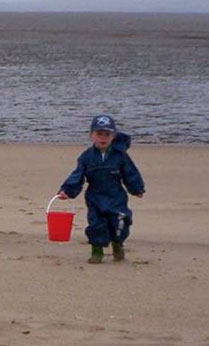 Elliott playing on the beach in our lovely British summer weather!