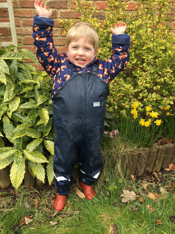 Sam's son, really happy in his new Ocean Rainwear dungarees!