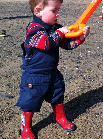 Thomas B in Warm and Dry dungarees playing on the beach