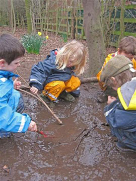 sticks...mud.... Waterproof World clothing.... fantastic Forest School play!