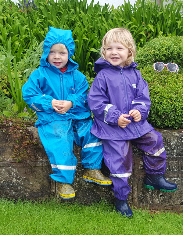 Archie and Connie well wrapped up for outdoor play in their Ocean Rainwear waterproof 2 piece suits of jacket and dungarees