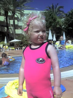 Emily M posing by the pool