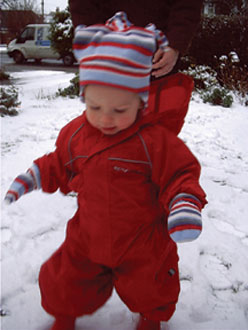Grace Mae discovering snow in Regatta Puddle Suit