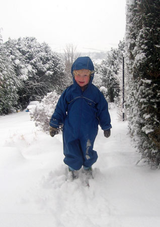 Luca in Puddle suit in snow