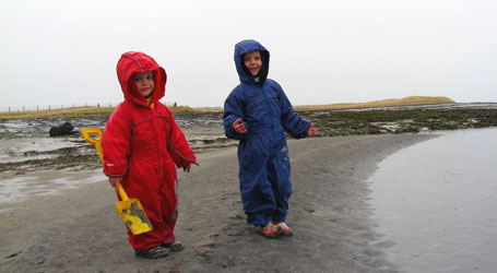 Gabby & Philip playing in Puddle Suits on the beach