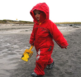 Philip playing in Puddle Suits on the beach